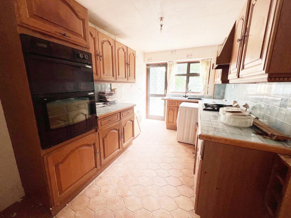 Lot: 19 - DETACHED BUNGALOW FOR REFURBISHMENT - Dark wood effect base cabinets drawers and eye level cupboards